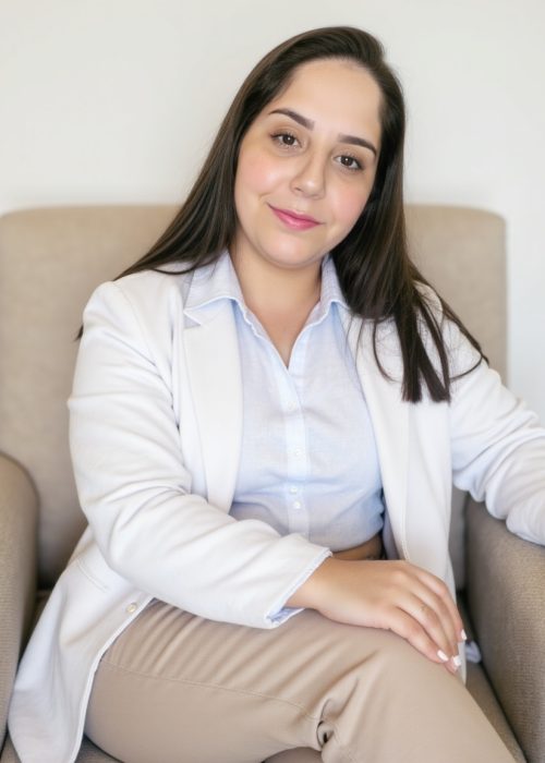 freepik__roberta-a-woman-is-seated-in-a-beige-armchair-wear__41055